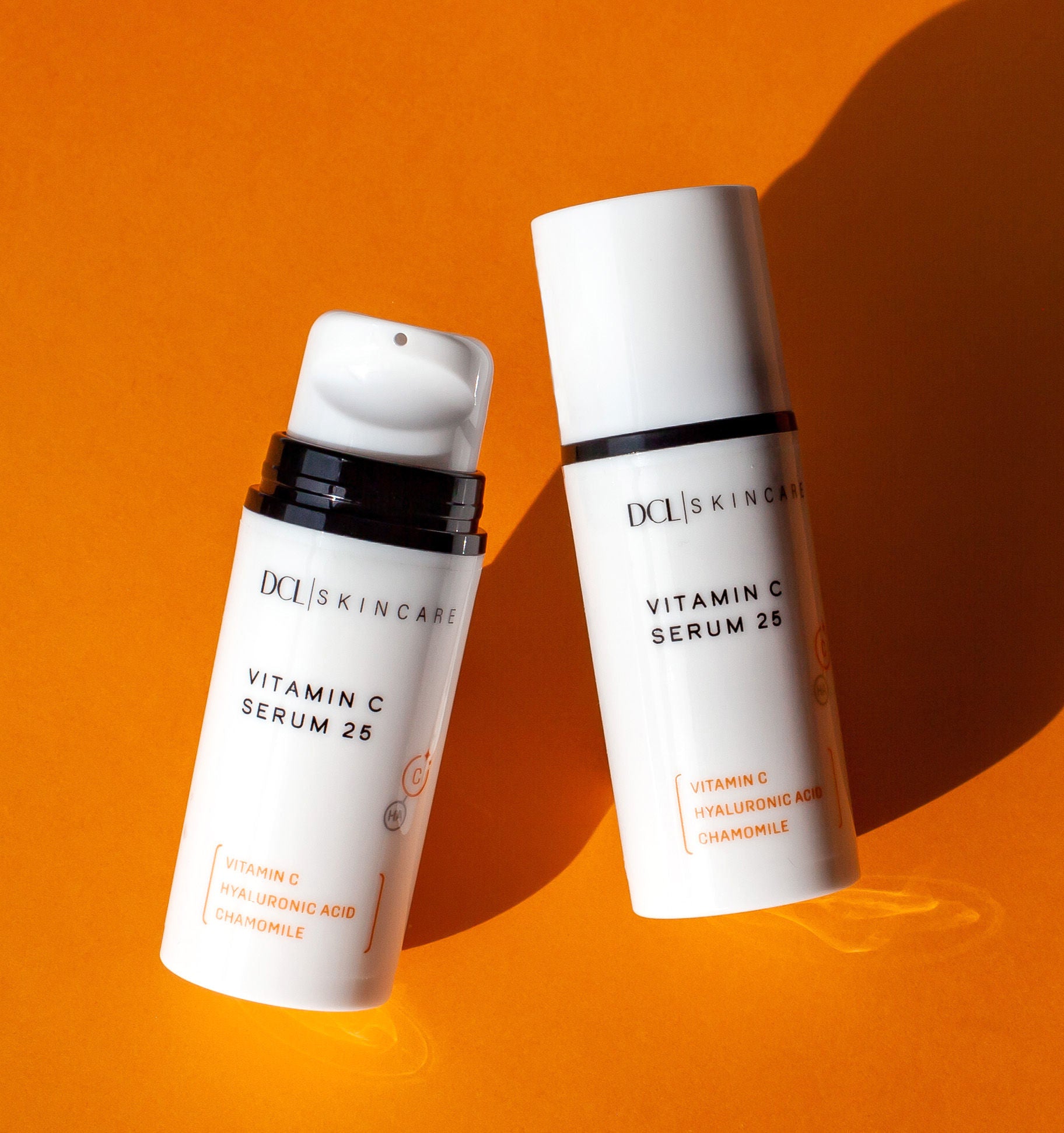 Vitamin C Serum flat lay Duo Cap and no cap on orange background