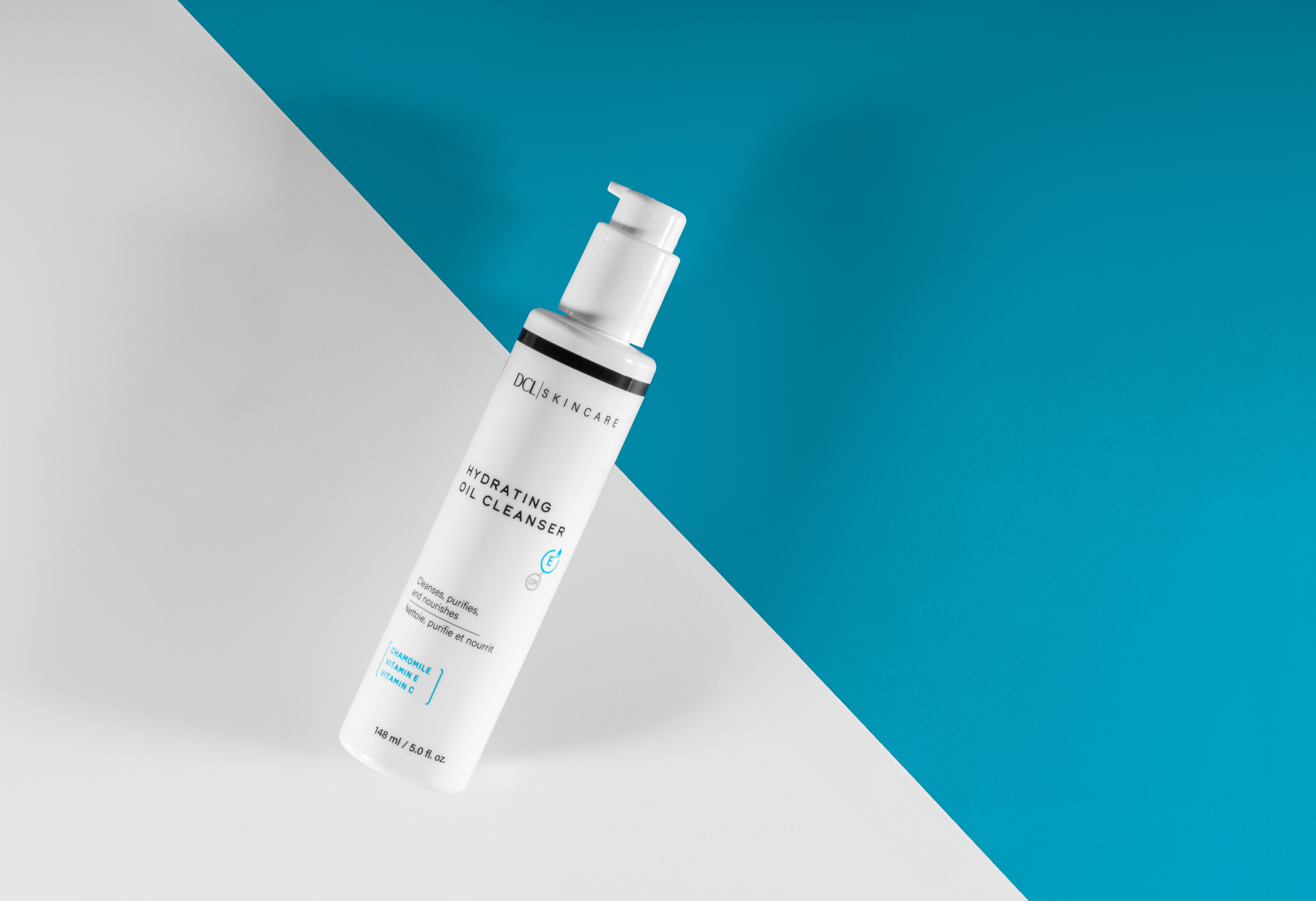 Hydrating Oil Cleanser flat lay over white and blue background