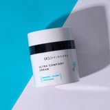 Ultra Comfort Cream flat lay on blue and white background