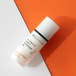 Vitamin C Night Booster 30 flat lay against white and orange background