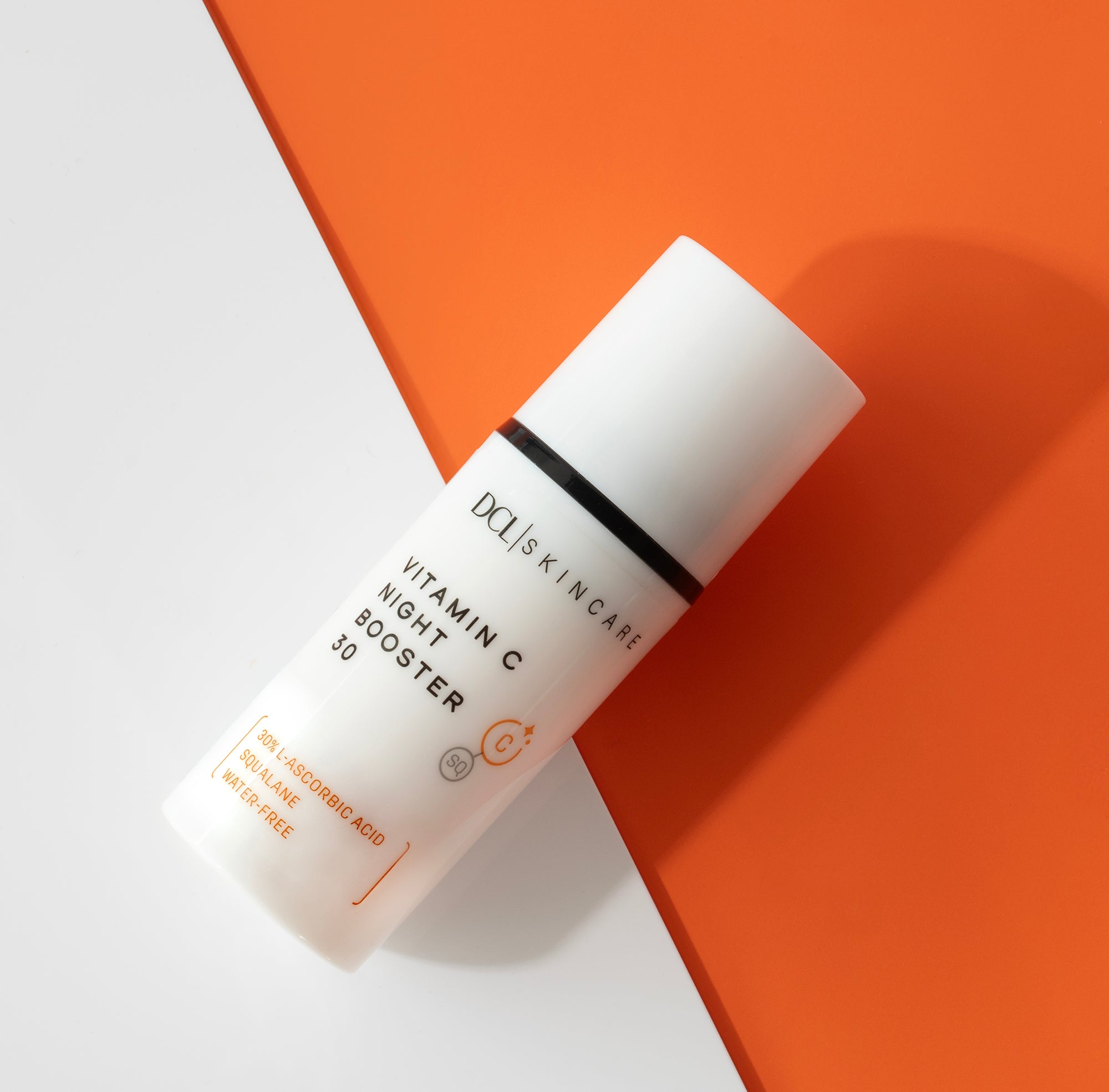 Vitamin C Night Booster 30 flat lay against white and orange background